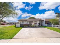 Charming single-story home with a well-maintained lawn and a quaint front garden at 3103 Yorych Ln, Orlando, FL 32822
