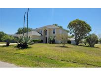 Charming two-story home with lush lawn and mature trees at 502 Eagle Ct, Kissimmee, FL 34759
