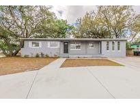 Charming single-story home with a well-maintained front yard and mature trees at 5500 Riviera Dr, Orlando, FL 32808