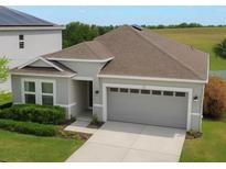 Charming single-Gathering home featuring a two-car garage and well-maintained lawn at 902 Grand Hilltop Dr, Apopka, FL 32703