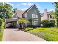 Charming two-story home with a well-manicured lawn and beautiful landscaping, plus convenient porte-cochere at 910 Alameda St, Orlando, FL 32804