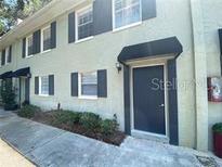 Two-story townhouse showing the front entry and garden area at 2141 Lake Margaret Dr # 11, Orlando, FL 32806