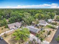Expansive aerial view of a property with lush green surroundings and a well-maintained neighborhood at 1104 E University Ave, Deland, FL 32724