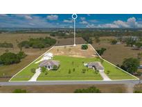 Expansive aerial view of property showcasing landscaping, acreage, and two homes with a separate garage at 11630 Flynn Ct, Winter Garden, FL 34787