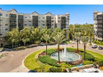 Upscale condominium with water fountain, lush greenery, and beautiful landscaping at 14501 Grove Resort Ave # 1441, Winter Garden, FL 34787
