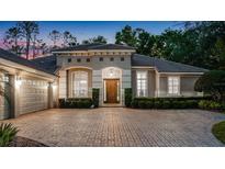 Stunning single-story home with a brick driveway and meticulously maintained landscaping at 3400 Oakmont Ter, Longwood, FL 32779