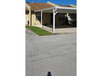 Charming townhouse with a covered carport and well-maintained front yard at 2218 Abbey Rd, Winter Haven, FL 33880