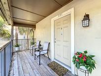 Cozy front porch featuring seating area and front door with a floral arrangement at 232 Afton Sq # 201, Altamonte Springs, FL 32714