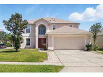 Charming two-story home featuring a two-car garage and well-maintained landscaping at 343 Grand Royal Cir, Winter Garden, FL 34787
