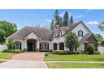 Charming single-story home with a beautiful brick driveway and a well-manicured front yard at 3535 Lake Sarah Dr, Orlando, FL 32804
