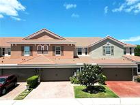 Inviting townhome with a charming tile roof, brick driveway, and well-maintained landscaping at 5510 Siracusa Ln, Sanford, FL 32771