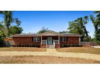 Charming single-story brick home with a welcoming front porch and a well-maintained gravel yard at 617 E Citrus St, Altamonte Springs, FL 32701