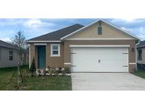 Charming single-story home with a well-manicured lawn and attached two-car garage at 976 Commons Way, Port Orange, FL 32129