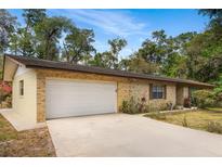 Charming single-story home with a two-car garage, brick exterior, and well-maintained landscaping at 180 Broadmoor Rd, Lake Mary, FL 32746