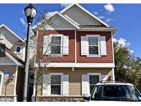 Charming two-story home featuring white shutters, a gable roof, and a well-maintained exterior at 7514 Sunville Ave, Kissimmee, FL 34747