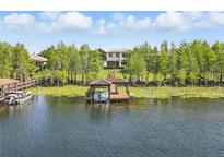 Lakefront home featuring a private covered boat dock for easy access to the water and endless recreational opportunities at 7624 Pointe Venezia Dr, Orlando, FL 32836