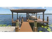 Waterfront home featuring covered boat dock with lift and beautiful water views at 7624 Pointe Venezia Dr, Orlando, FL 32836