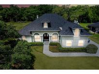 Charming single-Gathering home with lush landscaping, elegant arches, and a spacious front yard at 878 Cardinal Pointe Cv, Sanford, FL 32771