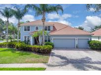 Charming two-story home boasts a three-car garage, lush landscaping, and a classic tile roof at 1786 Lee Janzen Dr, Kissimmee, FL 34744