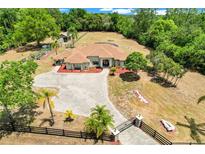 Stunning aerial view of estate home with expansive lawn and circular driveway at 32510 Wolf Branch Ln, Sorrento, FL 32776