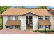 Inviting exterior view of a two-story condo building with brown roofing and well-maintained landscaping at 516 Bahia Cir # B, Ocala, FL 34472