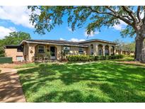 Tan-colored home with a well-maintained lawn and mature landscaping in a desirable neighborhood at 516 Polaris Loop # 110, Casselberry, FL 32707