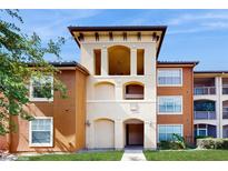 Inviting apartment building featuring a neutral color scheme and well-maintained landscaping at 5512 Metrowest Blvd # 203, Orlando, FL 32811