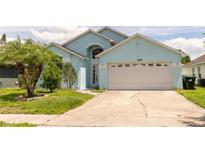 Charming single-Gathering home featuring a well-maintained lawn, two-car garage, and inviting curb appeal at 11547 Grazeley Ct, Orlando, FL 32837