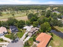 Stunning aerial view showcasing the neighborhood, golf course, and beautiful waterfront homes in a desirable location at 14037 Fairway Willow Ln, Winter Garden, FL 34787