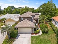 Attractive two-story home with a well-manicured lawn, tile roof, and an attached two-car garage at 14037 Fairway Willow Ln, Winter Garden, FL 34787