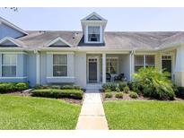Charming single-story townhome featuring a well-manicured lawn and inviting front porch area at 14262 Tanja King Blvd, Orlando, FL 32828