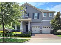 Charming two-story home with a three car garage and manicured landscaping at 16124 Azure Key St, Winter Garden, FL 34787