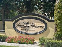 Beautiful community sign for Tuscany Preserve surrounded by flowers and greenery at 1840 Coriander Dr, Kissimmee, FL 34759