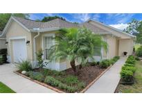 Charming single-story home with a well-manicured lawn, lush landscaping, and inviting curb appeal at 3018 Andover Ct, Mount Dora, FL 32757