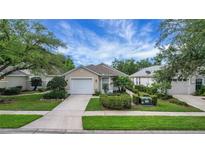 Charming single-story home featuring a well-manicured lawn and a two-car garage at 3018 Andover Ct, Mount Dora, FL 32757