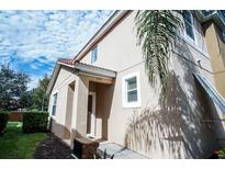 Inviting exterior of home featuring neutral stucco, red-tiled roof, and well-maintained landscaping at 550 Las Fuentes Dr, Kissimmee, FL 34746
