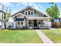 Charming home featuring a well-manicured lawn, brick walkway, and inviting front porch at 1017 Florida Ave, St Cloud, FL 34769