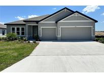 Charming single-story home with a well-maintained lawn and a spacious two-car garage at 4015 Maggie Loop, Lakeland, FL 33813