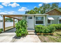 Charming home featuring a covered carport, a well-manicured lawn and garden with vibrant plants at 508 10Th St, St Cloud, FL 34769