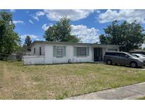 Charming single-story home featuring green shutters and patterned concrete accents with an attached garage and well-lit yard at 1371 W Wellington Dr, Deltona, FL 32725