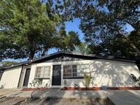 Charming single-story home with a modern black and white paint scheme and manicured landscaping at 1386 Clematis Ln, Winter Park, FL 32792