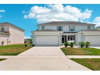 Charming two-story townhome with a well-maintained lawn and attached two-car garage at 1986 Yellowfin Dr, Port Orange, FL 32128