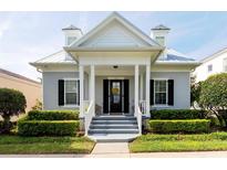 Charming home featuring a cozy porch, dormer windows, and neatly manicured landscaping, offering great curb appeal at 4148 Oak St, Orlando, FL 32814