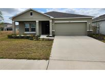 Charming single-Gathering home with a well-maintained lawn and a two-car garage at 4557 Ranunculus St, Haines City, FL 33844