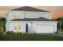 Charming two-story home with blue siding, a gray roof, a two-car garage and beautifully landscaped front yard at 5262 Foothills Preserve Loop, Mount Dora, FL 32757