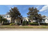 Charming single story home with mature trees and manicured landscaping at 7415 Devereaux St, Reunion, FL 34747