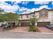Charming townhome with brick-paved driveway and attached two-car garage at 1227 Sandwedge St, Davenport, FL 33896