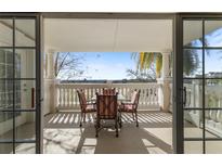 Inviting patio with table set and views of the surrounding green landscape at 1370 Centre Court Ridge Dr # 204, Reunion, FL 34747