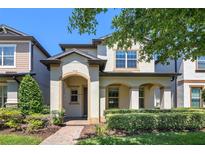 Charming two-story home featuring an inviting arched entryway and well-manicured landscaping at 14131 Lakeview Park Rd, Winter Garden, FL 34787