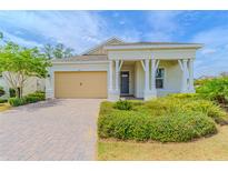 Charming single-story home with a well-manicured lawn and a welcoming front porch at 1598 Whitewood Ct, Kissimmee, FL 34747